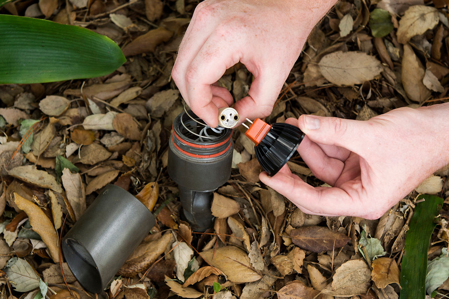 Maintenance and Repair lawn lighting being repaired