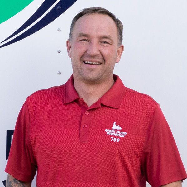 photo of Tobias Payne, owner of Green Island Irrigation, wearing a red shirt